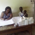 Clinical Officer attends to a mother with child